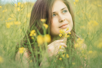 Sticker - beautiful romantic girl on blooming rapeseed field enjoying nature, young elegant woman walking,pretty female face, concept happiness , freedom, inspiration