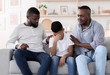 © Prostock-studio - Family Support. Black father and grandfather comforting upset little boy at home