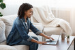 © Prostock-studio - Smiling Black Woman Disinfecting Laptop Keyboard Before Use At Home