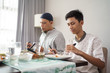 © Odua Images - muslim father and son eating some dinner together at home