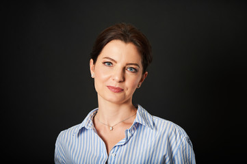 Studio business portrait of beautiful mature woman wearing blue stripe shirt