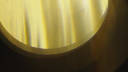 Wall Mural - warm lens flares elements on dark black background in studio. organically captured light elements