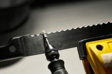 Professional Serrated Knife Blade Sharpening With A Rotary Tool. Macro Shot
