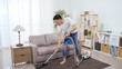 © PRPicturesProduction - asian househusband is vacuuming carpet in sitting room carefully. barefooted chinese guy is sweeping floor with vaccum cleaner slowly, trying to pay attention to every detail.