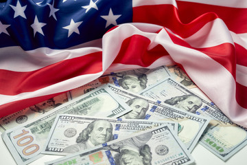 Close up of american flag and dollar cash money. Dollar banknote and United States flag background. Economy of USA