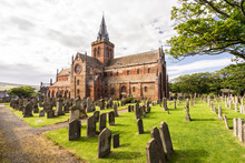 St Magnus Cathedral And Surrounding Gothic Graveyard In Kirkwall, Orkney Islands, Scotland. The Holy Red Sandstone Architecture Is Part Of The Church Of Scotland