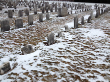 Old Cemetery Gravestones With Snow On Cold Winter Day