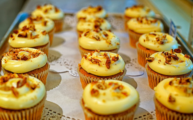 Wall Mural - Creamy cupcakes with nuts on the storefront reflex