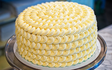 Wall Mural - Round creamy cake on the bakery storefront reflex