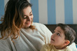 © LIGHTFIELD STUDIOS - happy mother and adorable son looking at each other in bedroom