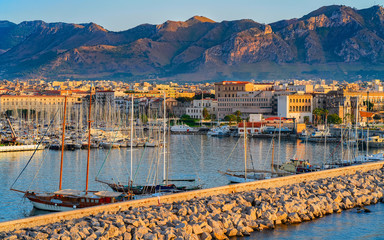 Wall Mural - Sunrise at Mediterranian sea and port in Palermo old city reflex