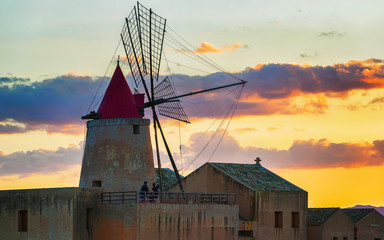 Sticker - Sunset at Windmill in salt evoporation pond of Marsala Sicily reflex