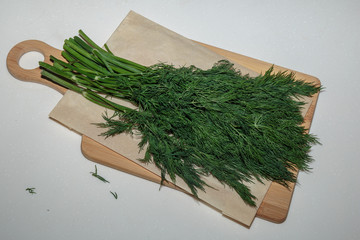 Wall Mural - Bundle of fresh dill on a cutting board.