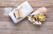 © jcsmilly - Spa wellness, exotic tropical plumeria flowers ,coconut soap,sea shells, white towels and coconut soap on wood background,top view