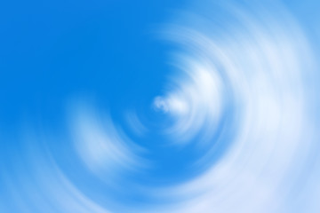 Blurred gradient radial motion light blue and white background. Mixed cloudy sky circular texture