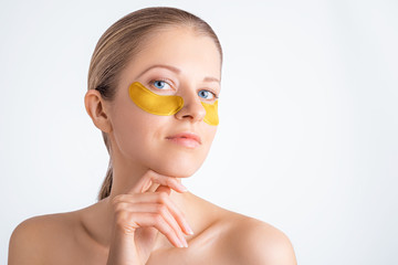 Wall Mural - cosmetology, skin care, face treatment, spa and self-care at home concept. woman with eye gel pads m
