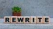 REWRITE word on cubes on an old gray background with cactus
