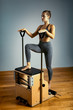 © Georgii - combo wunda pilates chair woman instructor fitness yoga gym exercise. Copy space. sports banner