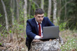 © alas_spb - a man with a laptop at the cottage. businessman in nature at work