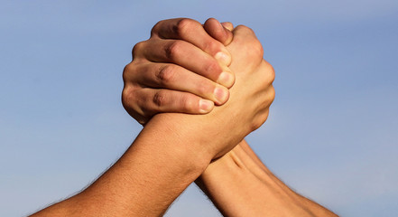 Hand, rivalry, vs, challenge, strength comparison. Two muscular hands. Rivalry concept. Two men arm wrestling. Arms wrestling. Friendly handshake, friends greeting, teamwork. Closep up, macro