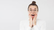 © Damir Khabirov - Horizontal banner of young amazed girl feeling surprised and shocked, shouting with OMG WOW face, isolated on gray background, copy space on left