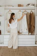 Young Woman Standing In Front Of Her Closet.