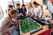© ivanko80 - Coworkers playing table football.
