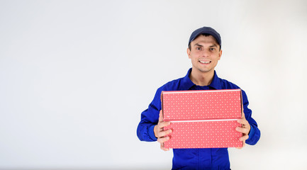 Young man courier in blue overalls