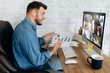 © Kateryna - Online business meeting. A young business man communicates by video conference with his business team about a work strategy and plan. Work from home