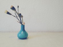 Flower Vase On Table Against White Wall