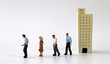 © Hyejin Kang - Miniature people walking out of miniature buildings.