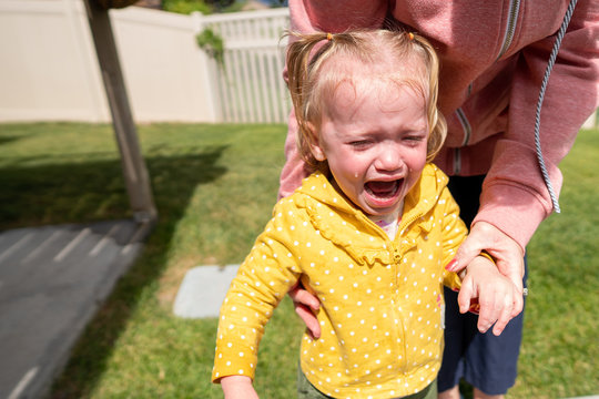 Girl toddle crying big tears outside