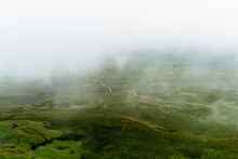 Scenic View Of Landscape Against Sky During Foggy Weather