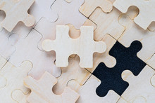 Wooden Jigsaw Puzzle Pieces On Black Background