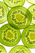 © The Picture Pantry - Macro shot of backlit kiwi fruit slices on white background. Top view layout