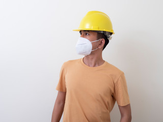 Asian industrial workers wear yellow hard hats, wear protective masks for their health