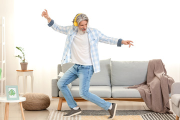 Wall Mural - Cool senior man dancing at home