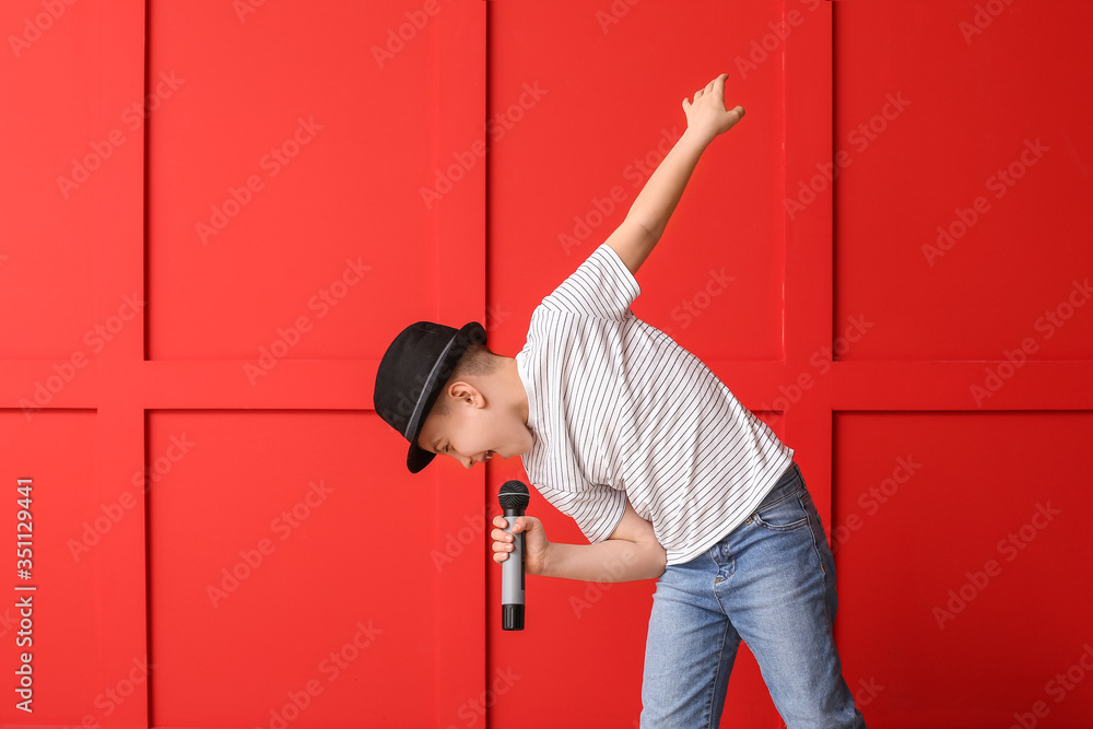 Cute little boy singing against color background Stock Photo | Adobe Stock