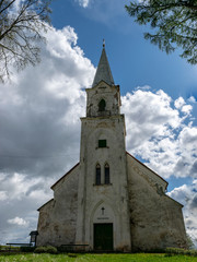 white church on the hill, beautiful blue sky with white cumulus clouds, Trikata church, Latvia