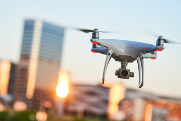 Wall Mural - drone with digital camera flying at city street