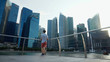 © YuriFineart - Traveller Looking At Singapore City Skyline and Bank Office Skyscrapers in Downtown