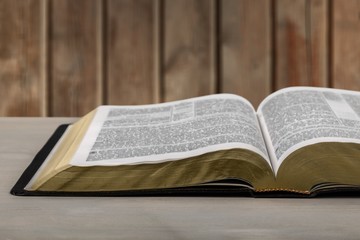 Wall Mural - open book on old wooden table.