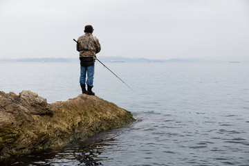 Sea fishing fisherman in the early morning