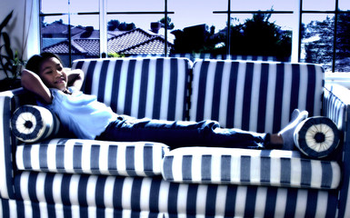 Poster - Side shot of girl resting on a striped couch