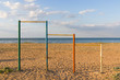 © mahovik - Large multi-colored turnstiles stand on the beach with clean blue sky.