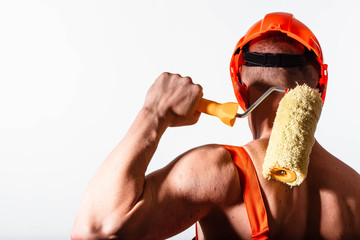 Sexy construction worker on a white background. Builder with a helmet on his head. Sexy builder.