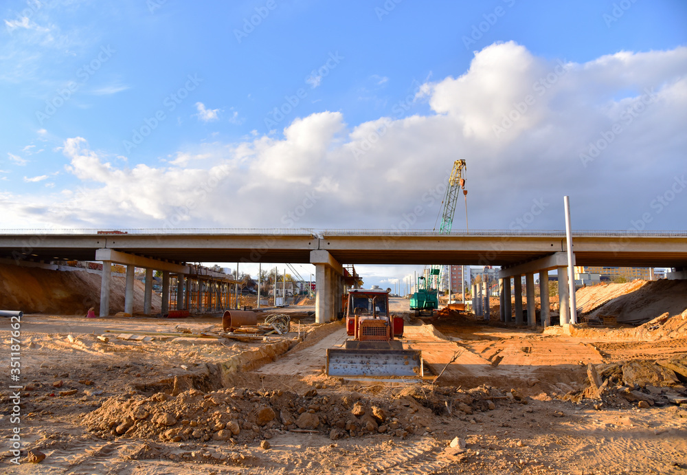 Bulldozer working at construction highway ramps and bridgeworks ...