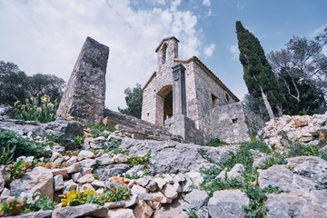 Wall Mural - Ancient small catholic chapel made from stones with tiled roof.