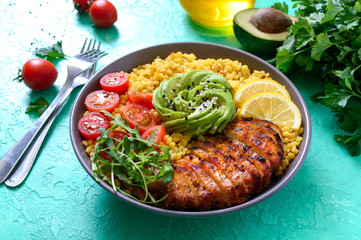 Wall Mural - Bulgur with grilled chicken fillet, fresh vegetables, avocado, greens. Diet lunch. Healthy food.