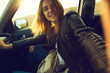 © Evgeny Lobanov - A girl making selfie portrait in the car with view